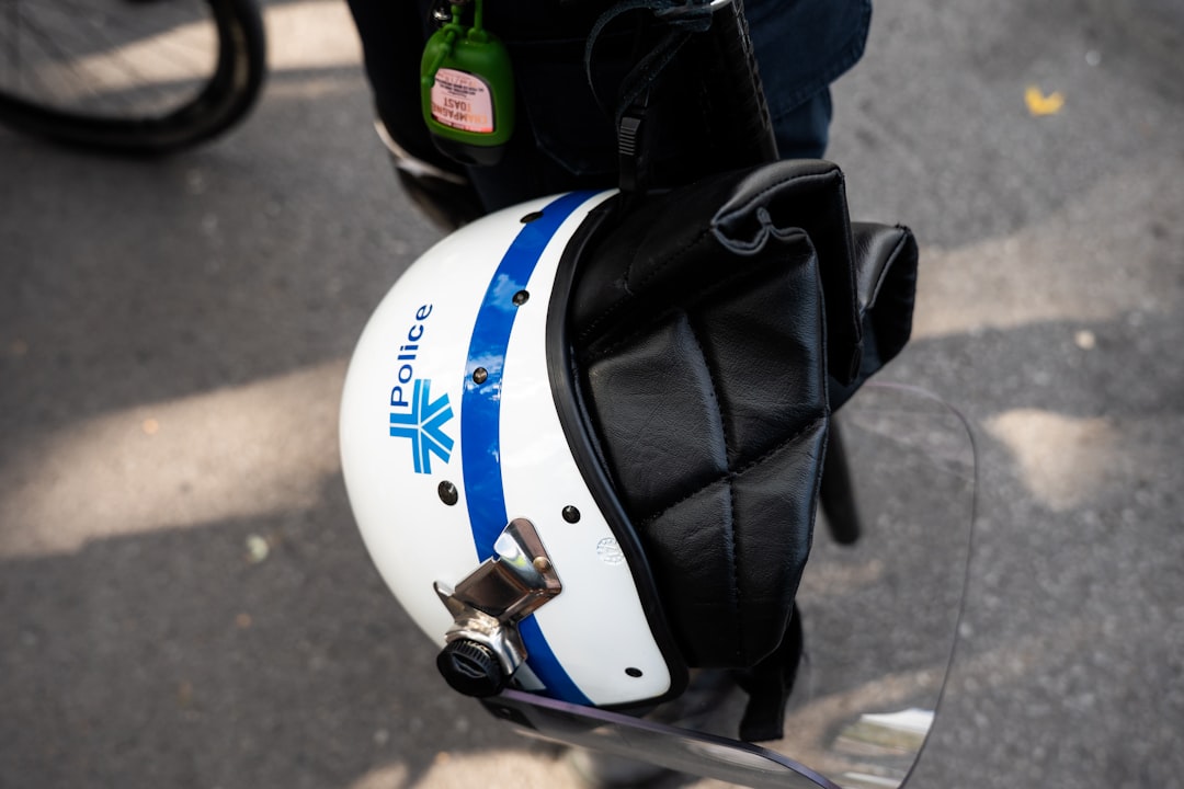 Police helmet with blue stripe and badge